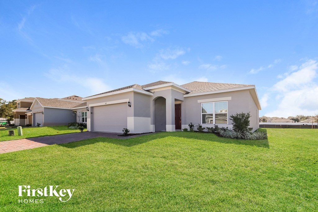 A house with a lawn in front of it and the words "FirstKey Homes" on the bottom left.