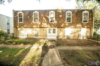 a large house with a fence in front of it