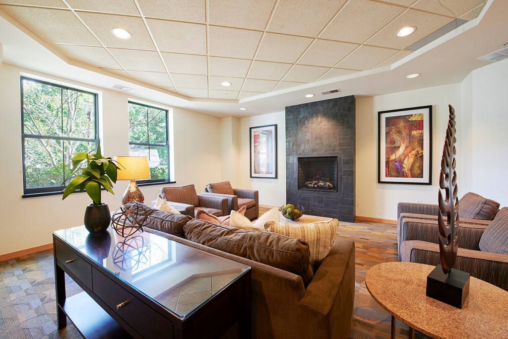 A seating area with a couch, chairs, and a fireplace.