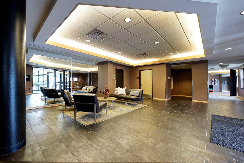 A spacious lobby with a seating area and a large mirror.