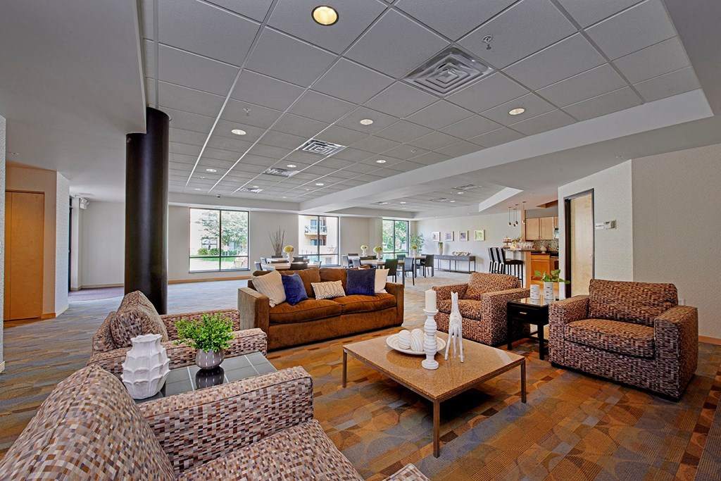 A seating area with a sofa and chairs.