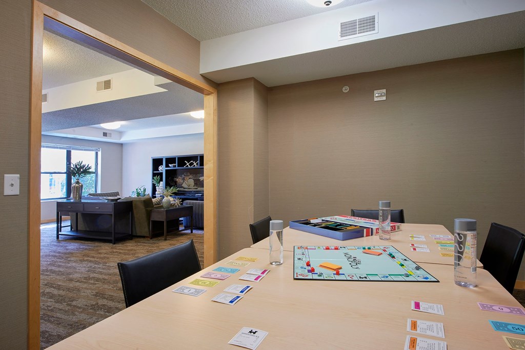 A conference room with a long table with a board game on it.