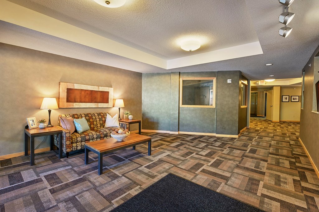 A lobby with a couch and coffee table.