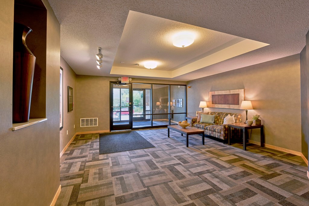 A lobby with a couch and coffee table.