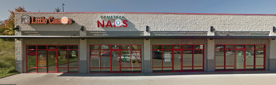 the front of a restaurant with red doors and windows