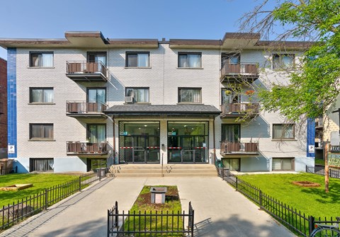 an apartment building with a courtyard and a glass front door