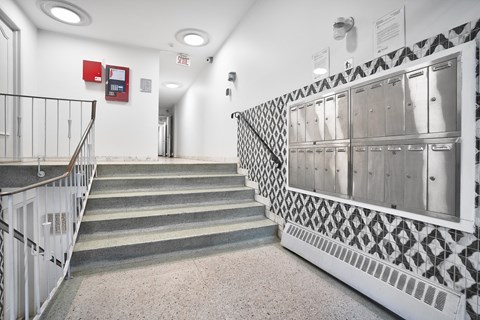 A staircase with a black and white patterned railing.