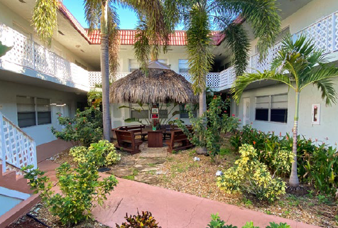 a courtyard with a table and chairs in front of a building