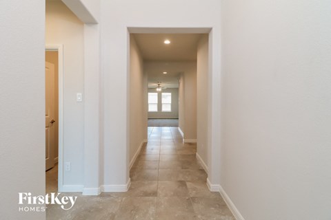 A long hallway with a light at the end.