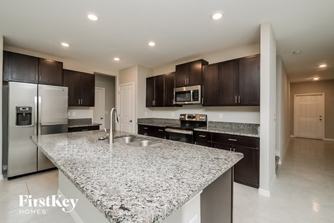 a modern kitchen with granite counter tops and stainless steel appliances
