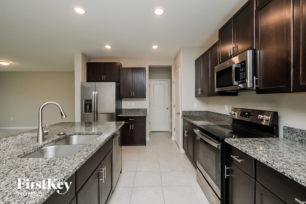 a kitchen with granite counter tops and stainless steel appliances