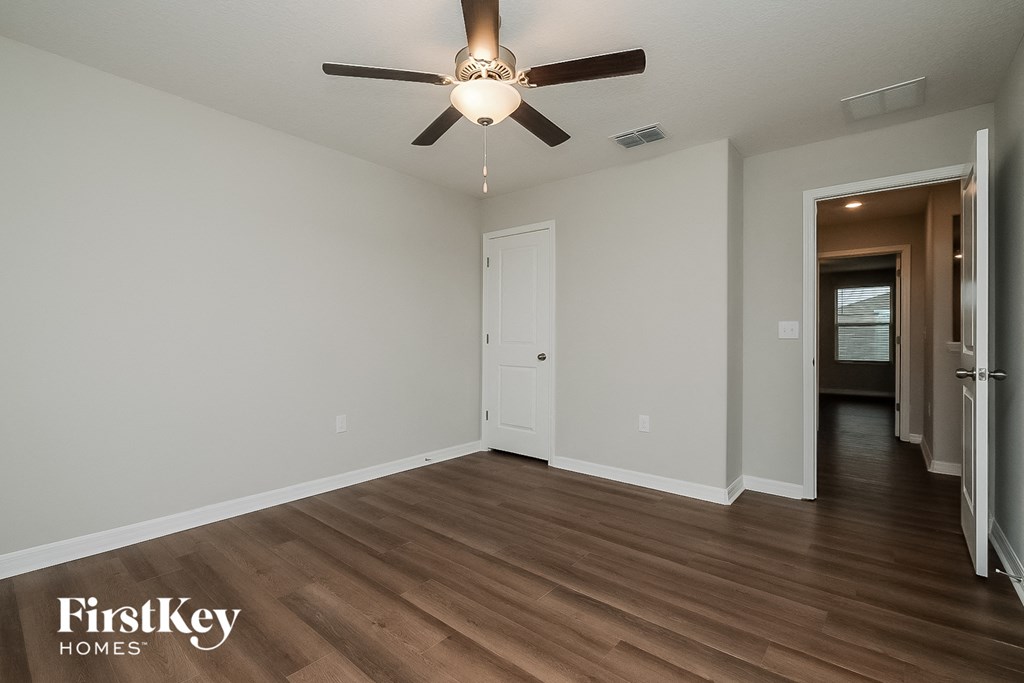 a living room with hardwood floors and a ceiling fan