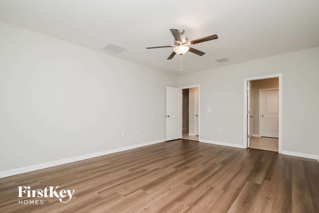a living room with hardwood floors and a ceiling fan