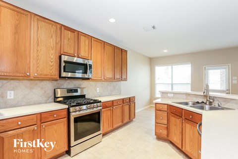 a kitchen with wooden cabinets and stainless steel appliances