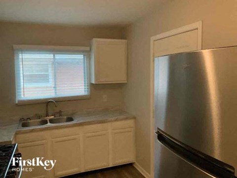 a kitchen with a stainless steel refrigerator and a sink