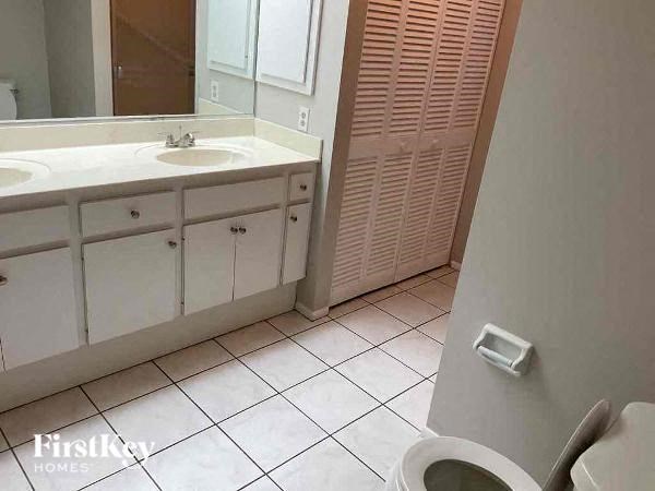a bathroom with a toilet and a sink and a mirror