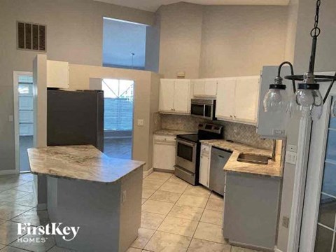 a kitchen with stainless steel appliances and marble counter tops