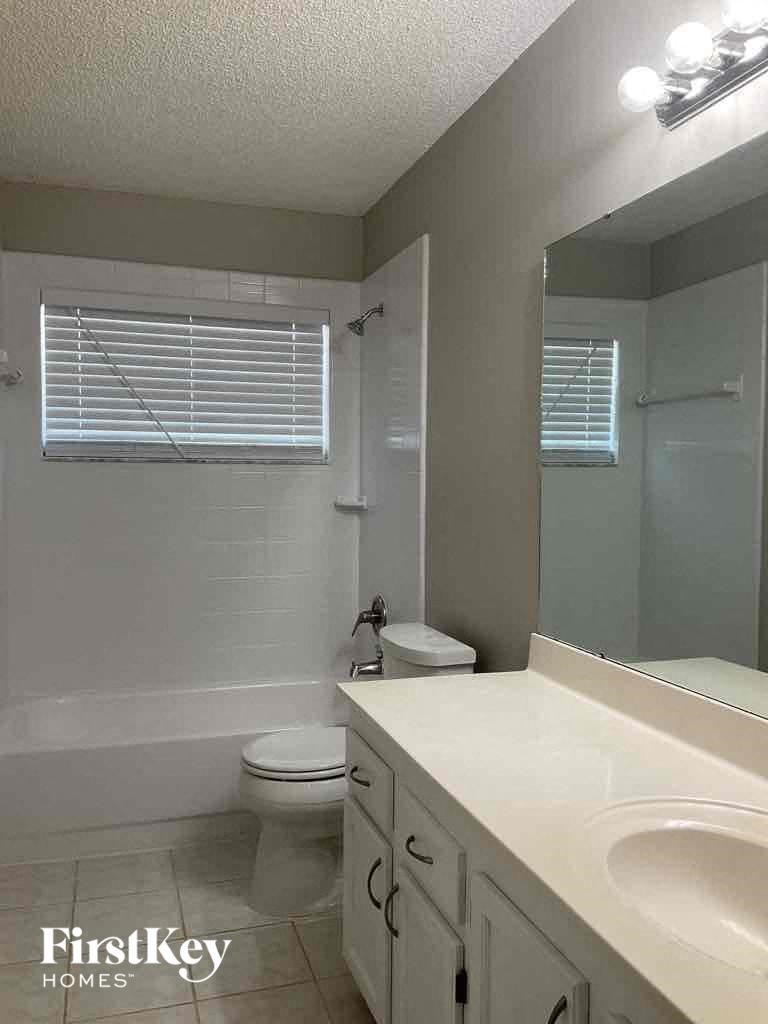 a bathroom with a sink and a toilet and a mirror