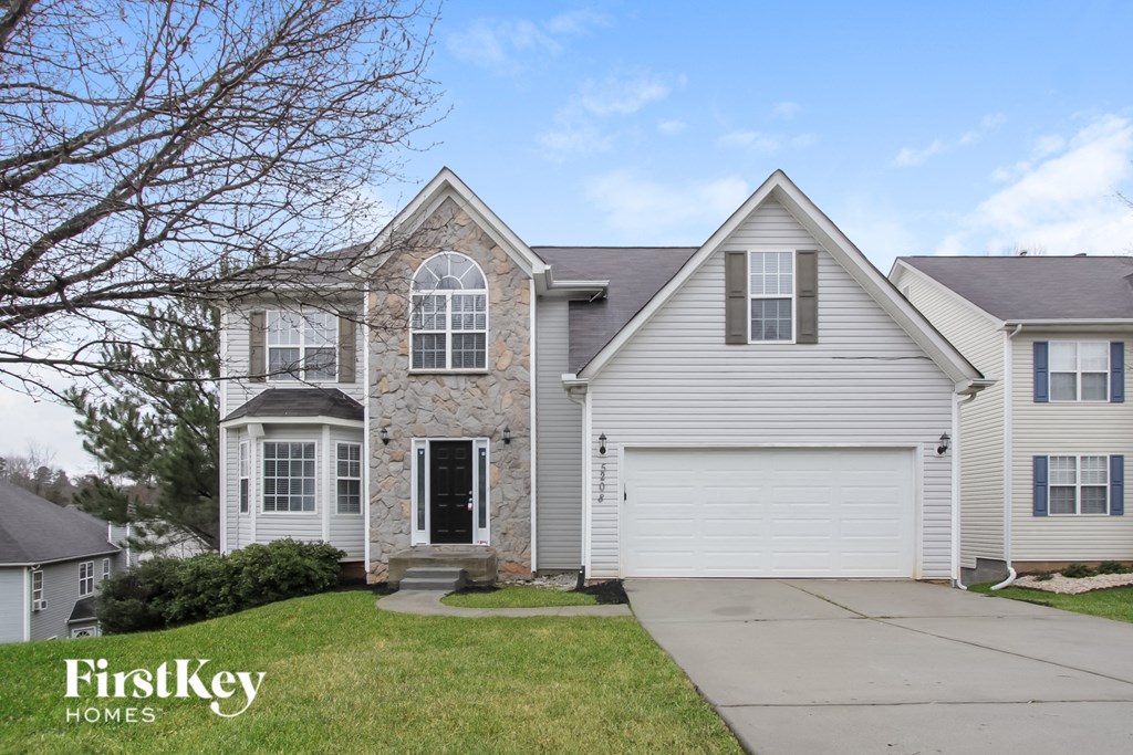 a white house with white siding and a white garage door