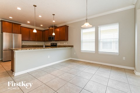 A kitchen with brown cabinets and a white countertop.
