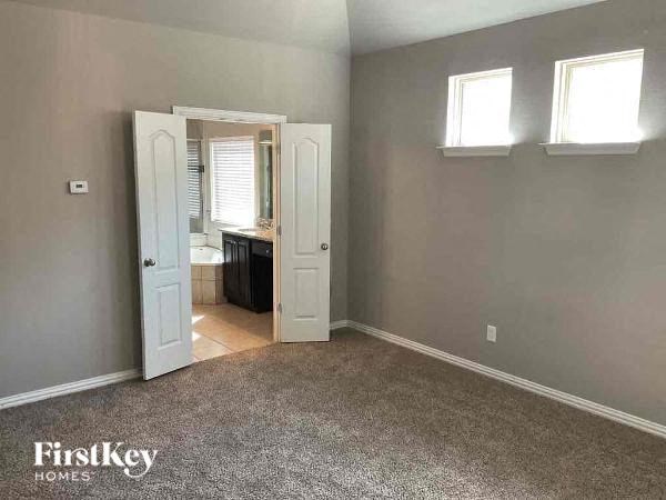 an empty room with a door to a bathroom