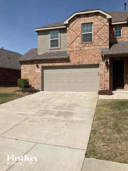 a driveway in front of a house with a garage door