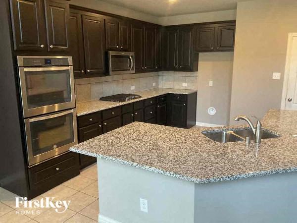 a kitchen with granite counter tops and stainless steel appliances