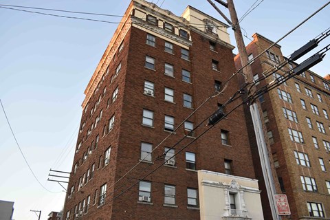 a tall brick building with power lines in front of it