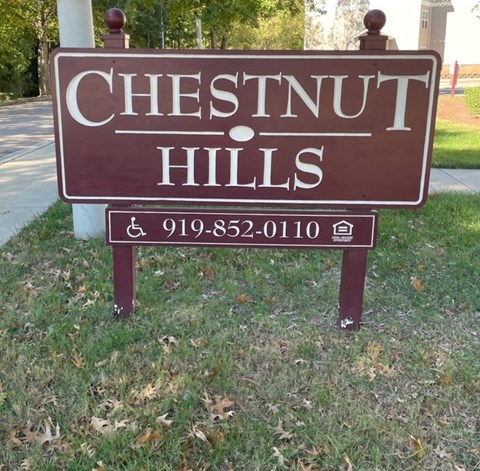 a sign that reads chestnut hills in the grass