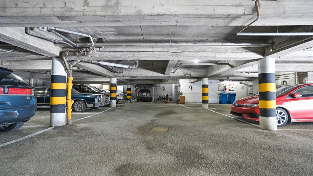 parking spaces in a parking garage with cars
