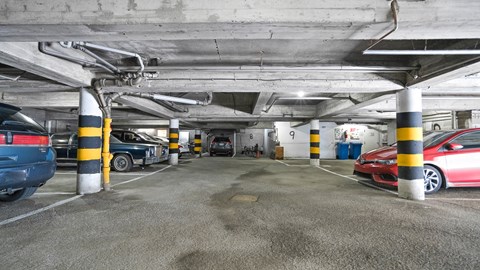 parking spaces in a parking garage with cars