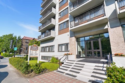 A modern apartment building with a sign in front that reads "ALBERT AR-73144".