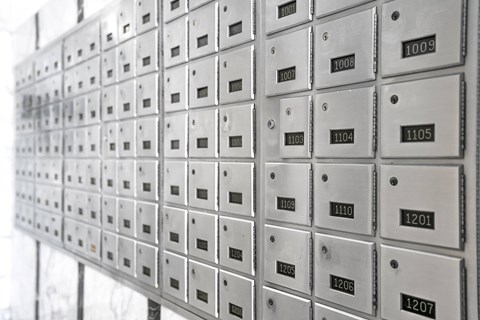 A wall of mailboxes with numbers ranging from 1009 to 1207.