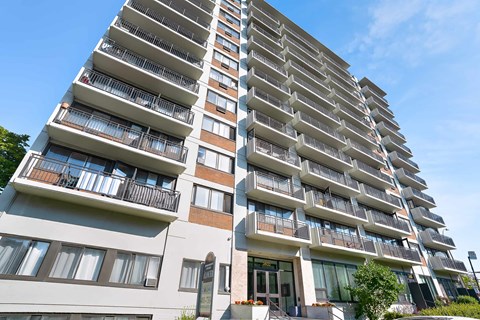 A tall residential building with balconies on each floor.