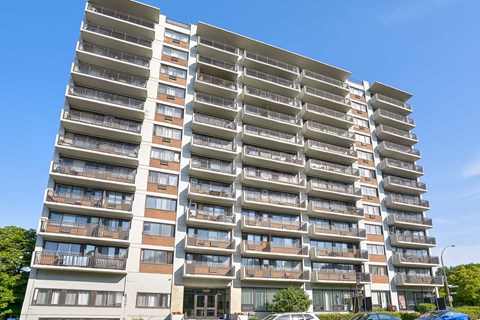 A large residential building with multiple balconies and windows.