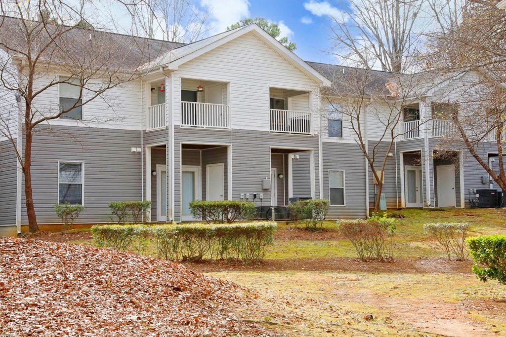 a white house with a yard in front of it