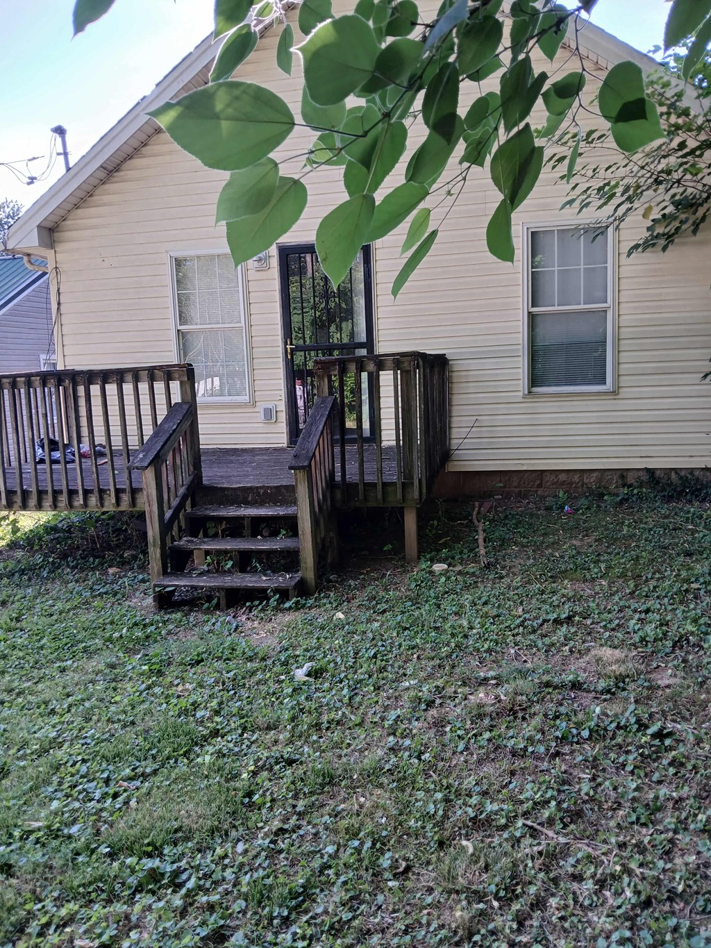 the front of the house with a wooden deck