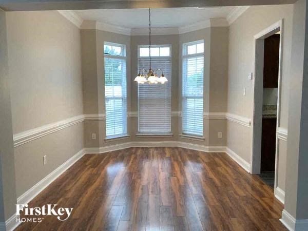 an empty living room with a hard wood floor