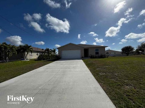 a house with a white garage door on the side of a driveway
