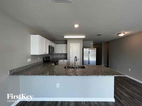 a kitchen with a granite counter top and a sink