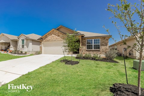 a home with a lawn and a sidewalk in front of it