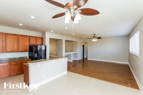 A kitchen with wooden cabinets and a white island.