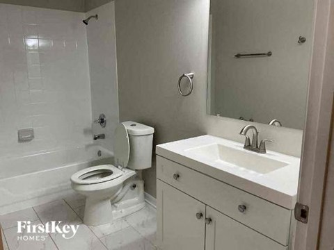 a white bathroom with a toilet and a sink