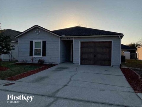 a white house with a driveway and a garage door