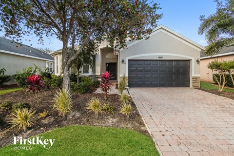 a house with a driveway and a black garage door