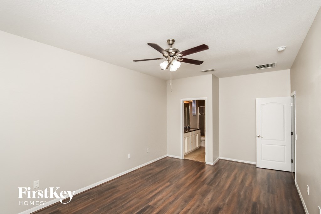 a living room with hardwood floors and a ceiling fan