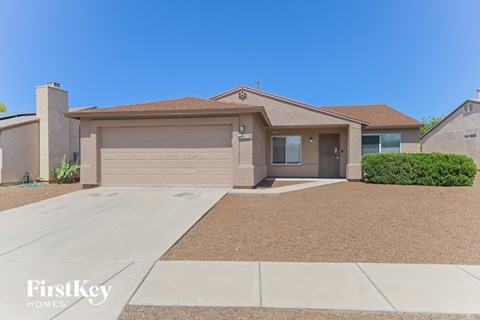 A house with a brown roof and a garage door is for sale.