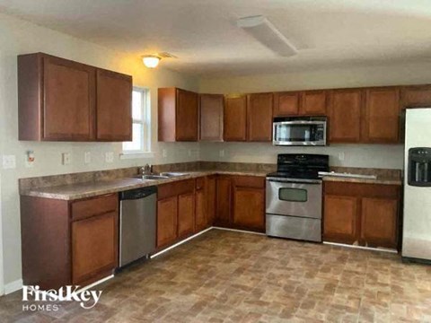 a kitchen with wooden cabinets and stainless steel appliances