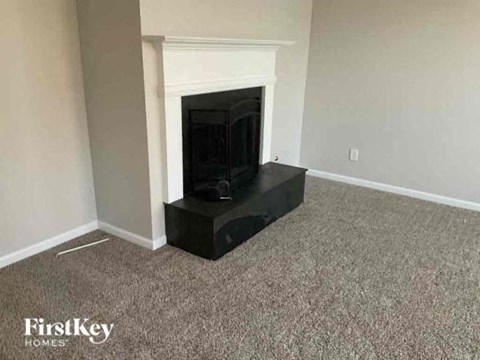 a living room with a fireplace and a carpet