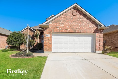 a home with a white garage door in front of it